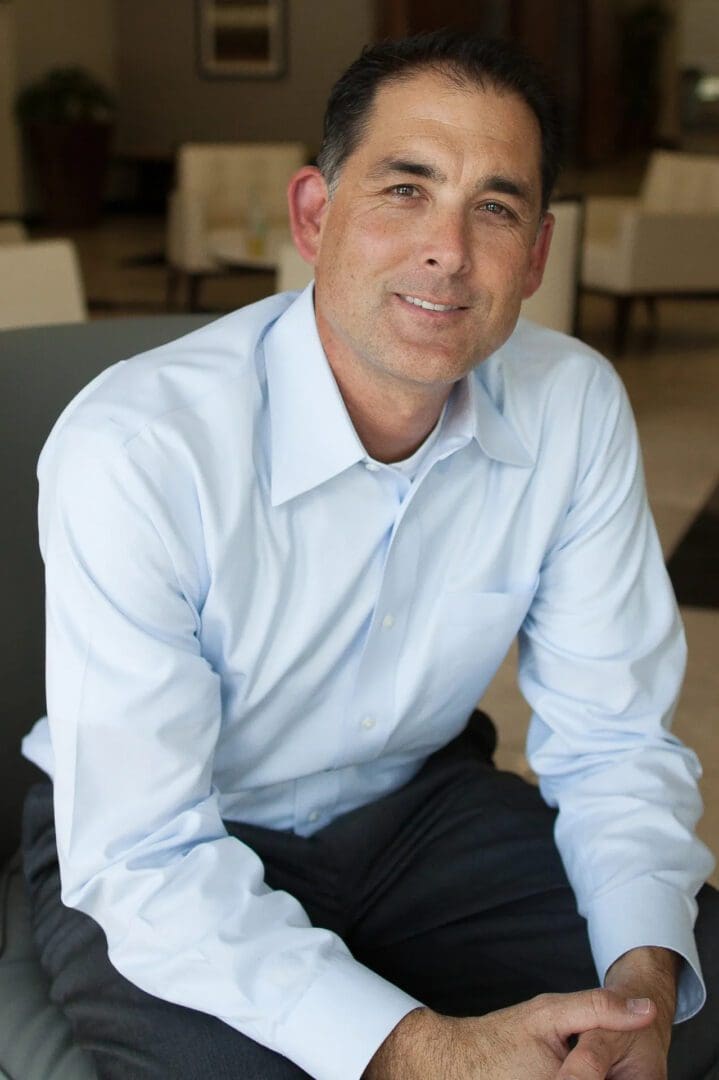 A man in a blue shirt and black pants.