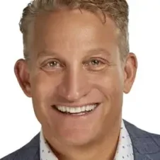 A man with blonde hair and a smile.